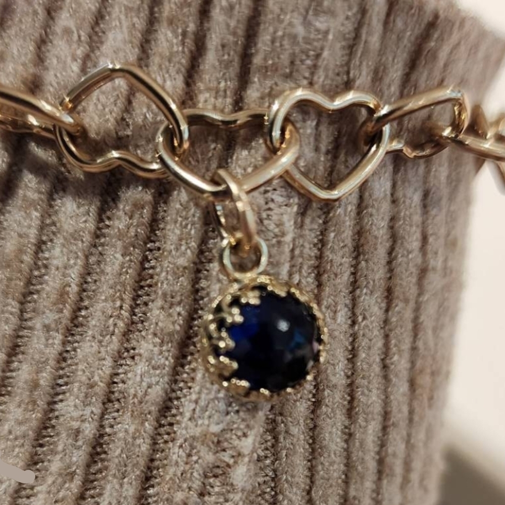 14k gold charm with a beautiful sapphire lab grown gemstone